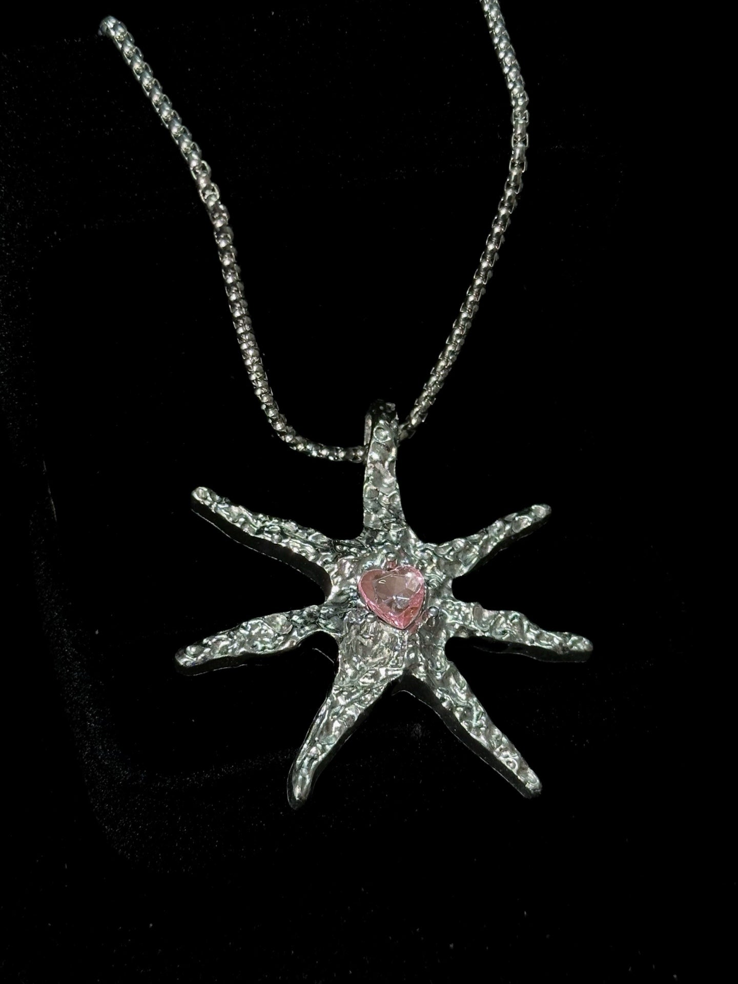 Spiked Starfish & Filigree Cross Heart Necklace Set close-up detail view showing dark finish